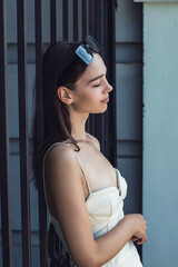 The girl poses at the iron gate.