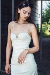 The girl poses at the iron gate.