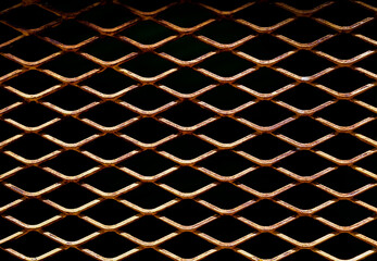 Empty black perforated rust metal grid with diamond holes for abstract rusty metallic mesh plate background, rust steel mesh texture. seamless patterns, space for work, vintage wallpaper,close up.