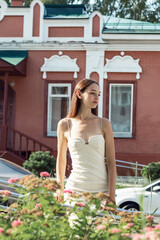 The girl walks around the summer city.