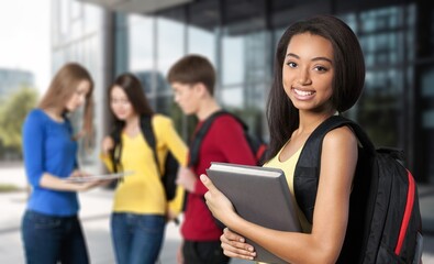 Student standing outdoor, ready for study in university