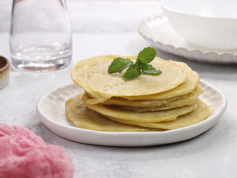 raw of roti canai or paratha (Parotta) flat bread, or also known as roti maryam in indonesia. Frozen food. usually sell in frozen food store