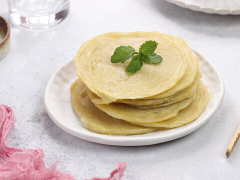 raw of roti canai or paratha (Parotta) flat bread, or also known as roti maryam in indonesia. Frozen food. usually sell in frozen food store