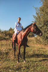 A girl walks on a horse.
