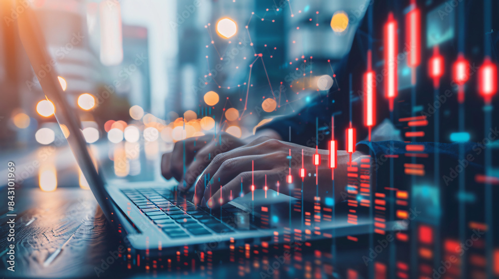 Poster close-up of hands typing on a laptop with glowing stock market graphs overlay