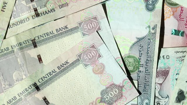 AED dirhams banknotes on the table, slow rotating motion
