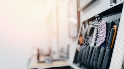 Barbershop hairdresser tools scissors and comb in box with sunlight , blue toning color