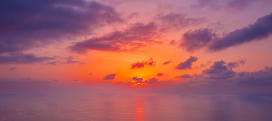 Banner beautiful sunset cloudy sky with sunlight from aerial top view, toning. Drone panorama Phuket photo above clouds