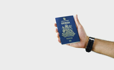 Man holding Grenada Passport in hand on white background with copy space - Grenadian