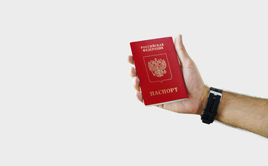 Man holding Russia Passport in hand on white background with copy space - Russian