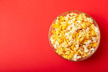 Tasty popcorn in color background. Cinema and entertainment concept. Movie night with popcorn.Cheese and caramel popcorn. Delicious appetizer, snack. Place for text. Copy space.Banner