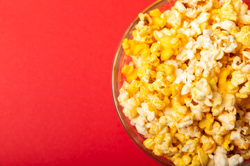 Tasty popcorn in color background. Cinema and entertainment concept. Movie night with popcorn.Cheese and caramel popcorn. Delicious appetizer, snack. Place for text. Copy space.Banner