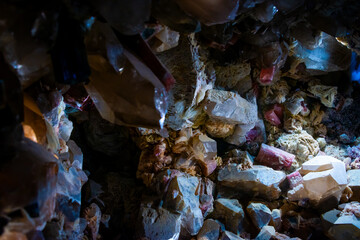 small mineral cave with different color gems. Raw crystals and other stones.