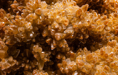 Orange mineral gem close up making a interesting background in geology. Unpolished Crystals as...