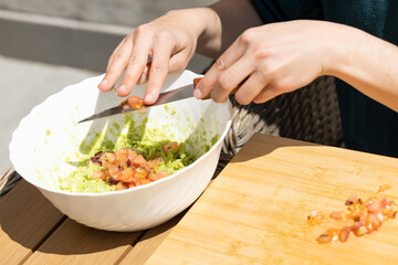 making homemade guacamole with different vegetables. culinary arts