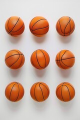 Obraz premium Group of orange basketballs sitting on a clean white surface