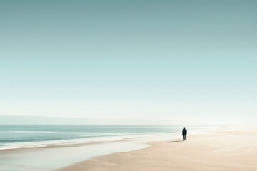 Obraz premium A person strolling along the shoreline, with the vast ocean in the background