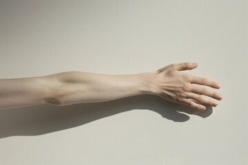 A close-up image of a person's hand resting on a white surface, with the fingers slightly curled and the palm facing upwards