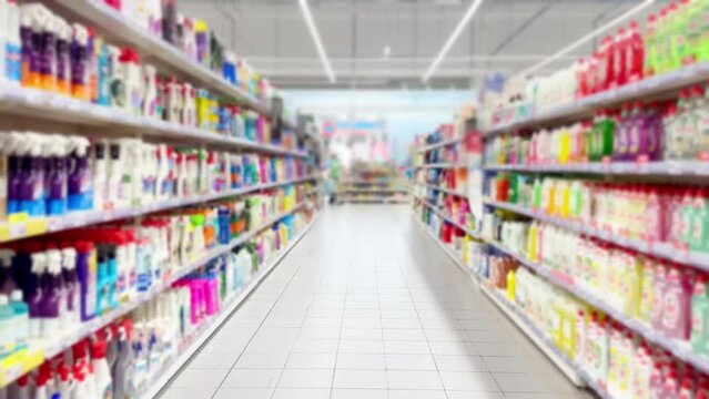 shopping at the  supermarket reading product information.(washing gel, detergents, conditioner)