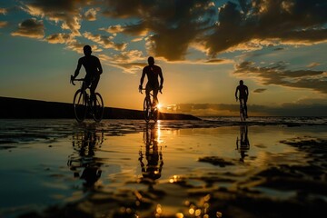 Aerial view of two people riding bicycles on a sandy beach, with the ocean in the background