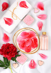 Fragrant pink salt, rose water and rose and peony flowers. Spa and wellness composition, aromatherapy and skin care, lifestyle and organic cosmetics concept, salon invitation and advertisement