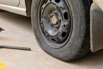 Fototapeta premium Punctured Car Tyre on Asphalt Road