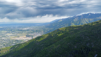 Fototapeta premium Aerial Views of Richmond Utah Canyon Mountain Range and Cache Valley Area with Incoming Storm Clouds