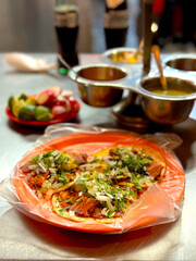 Tacos Al Pastor - Traditional Mexican Street Tacos made with Marinated Grilled Pork and Served on Tortillas with Pineapple, Onions, Cilantro, Lime and Radish.