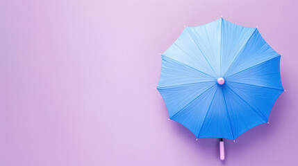 minimalist pastel blue umbrella on soft light pink backgroun, with copy space for text