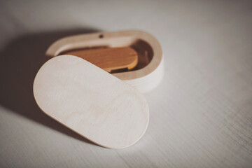 wooden usb flash drive on a white table. Wooden usb flashdisk in the wooden box isolated in white background. 