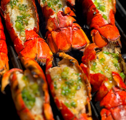 Grilled Lobster Tails with Garlic Lemon Butter Sauce Topped with Green Onions. Closeup Pictures During Preparation and Grilling. Summer Seafood Barbecue  