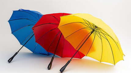 three colorful umbrellas stretched out against a white background, showcasing their vibrant colors and design.