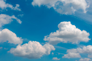 Beautiful white fluffy cloud floating in blue sky in sunny day, Cumulus are clouds which have flat bases and are often described as puffy, Horizon nature background with free copy space.