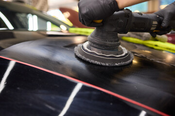 Person using machine to polish cars automotive exterior