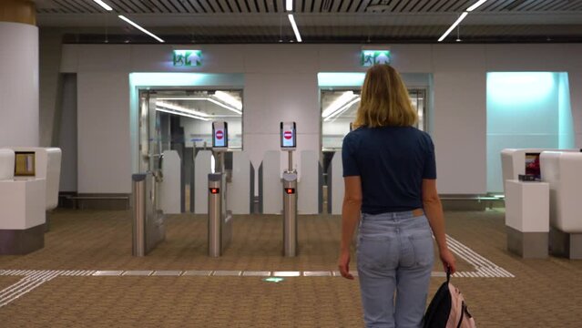 Access control systems in international airport. Validator. Checkpoint. Passenger Tapping Boarding Pass At Automated Self-boarding Gate Of An Airport.