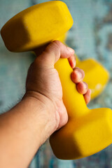 8 pound yellow weights on a rustic wooden table