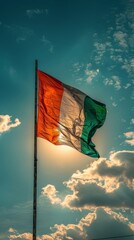 The vibrant flag of Ireland waves majestically against a stunning sunset backdrop with blue skies and scattered clouds