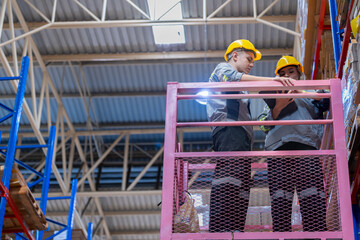 workers man and woman using a hydraulic scissor lift to check stock near the shelves warehouse. industry factory warehouse. Worker Screening Package In Warehouse.