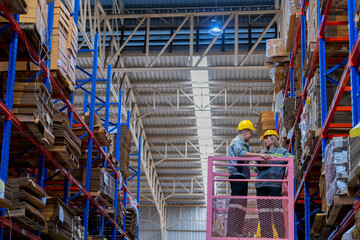 workers man and woman using a hydraulic scissor lift to check stock near the shelves warehouse. industry factory warehouse. Worker Screening Package In Warehouse.