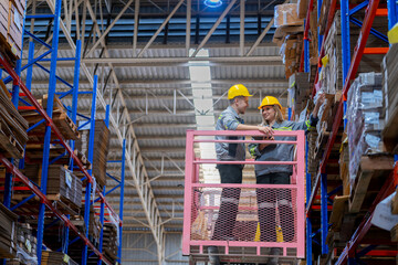 workers man and woman using a hydraulic scissor lift to check stock near the shelves warehouse. industry factory warehouse. Worker Screening Package In Warehouse.