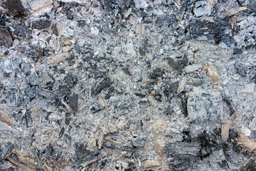 Natural ash from burnt wood and coals. Top view of ashes after fire close up