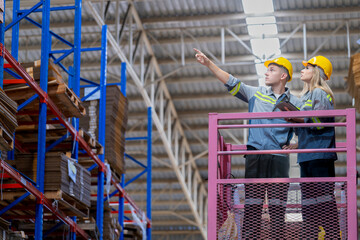 workers man and woman using a hydraulic scissor lift to check stock near the shelves warehouse. industry factory warehouse. Worker Screening Package In Warehouse.