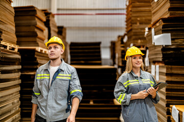 man and woman worker walking and checking stock for shipping. Female inspecting the store factory. Logistics employees holding folders at on site warehouse area for shipping transportation.