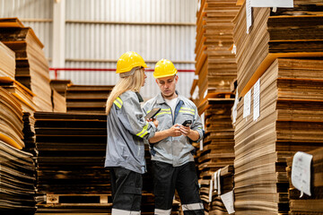 Fototapeta premium man and woman worker walking and checking stock for shipping. Female inspecting the store factory. Logistics employees holding folders at on site warehouse area for shipping transportation.