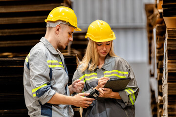 man and woman worker walking and checking stock for shipping. Female inspecting the store factory. Logistics employees holding folders at on site warehouse area for shipping transportation.