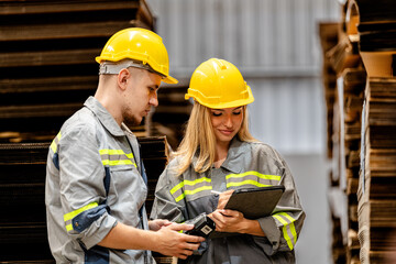 man and woman worker walking and checking stock for shipping. Female inspecting the store factory....