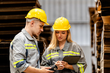 man and woman worker walking and checking stock for shipping. Female inspecting the store factory. Logistics employees holding folders at on site warehouse area for shipping transportation.