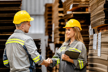 man and woman worker walking and checking stock for shipping. Female inspecting the store factory....