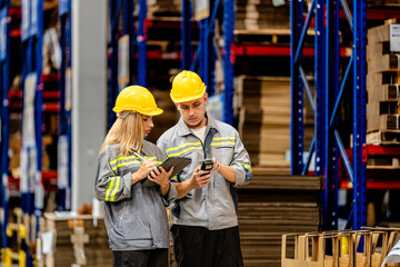 man and woman worker walking and checking stock for shipping. Female inspecting the store factory....