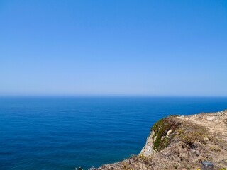 Fototapeta premium View of the coast from Cape Roca (Cabo da Roca), the westernmost point of the Sintra Mountain Range, of mainland Portugal, of continental Europe and of the Eurasian landmass